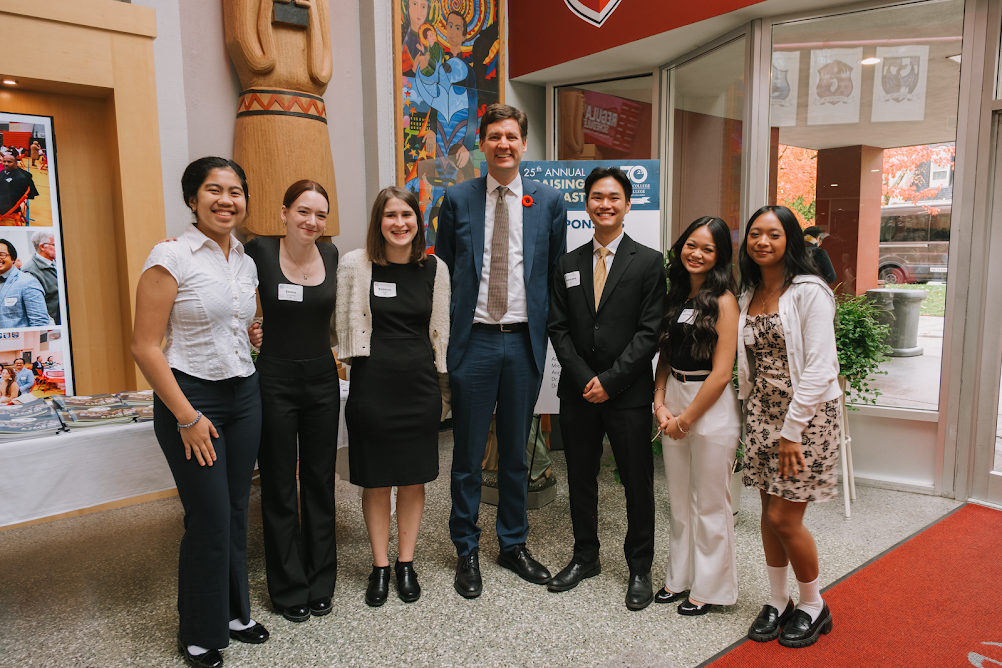 Students pose for a photo with Premier David Eby at the 25th Annual Fundraising Breakfast.